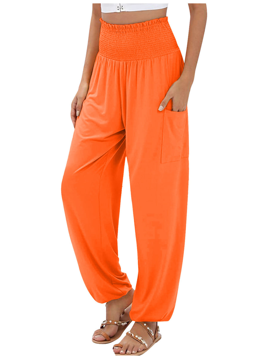 Orange smocked waist harem pants with pockets and ankle cuffs.