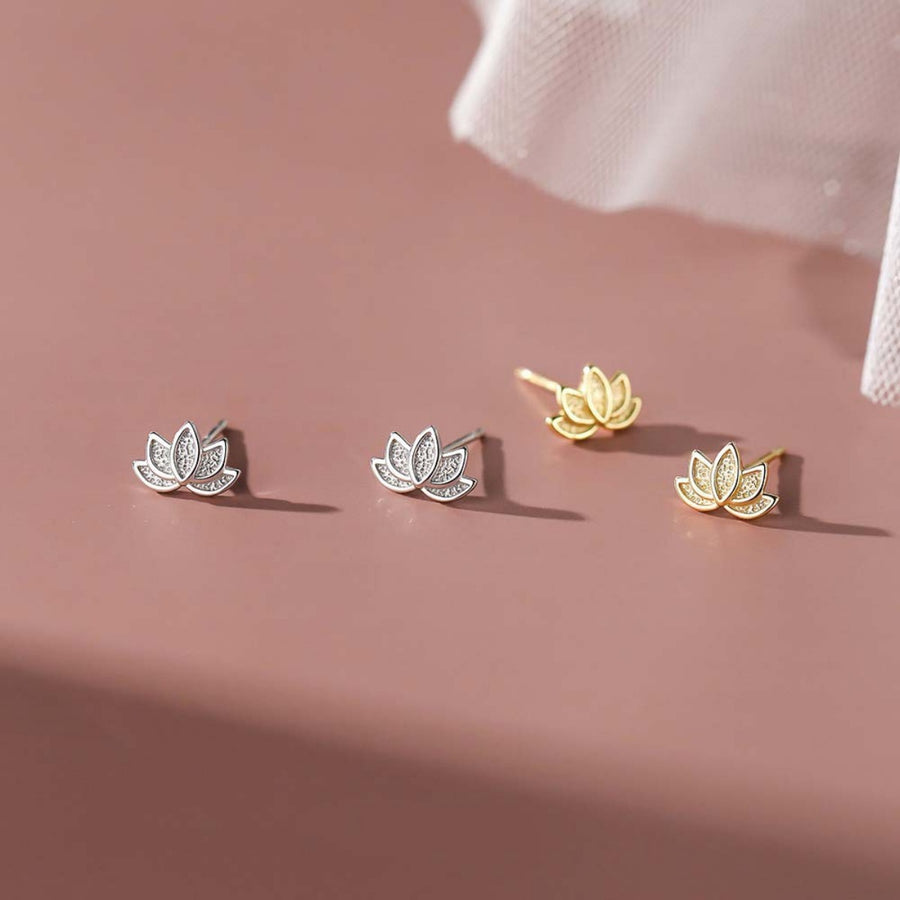 Gold and silver lotus flower stud earrings with delicate detailing