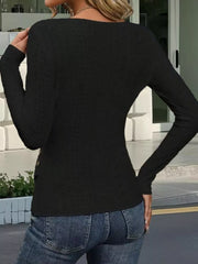 Black eyelet wrap t-shirt with decorative buttons and long sleeves.