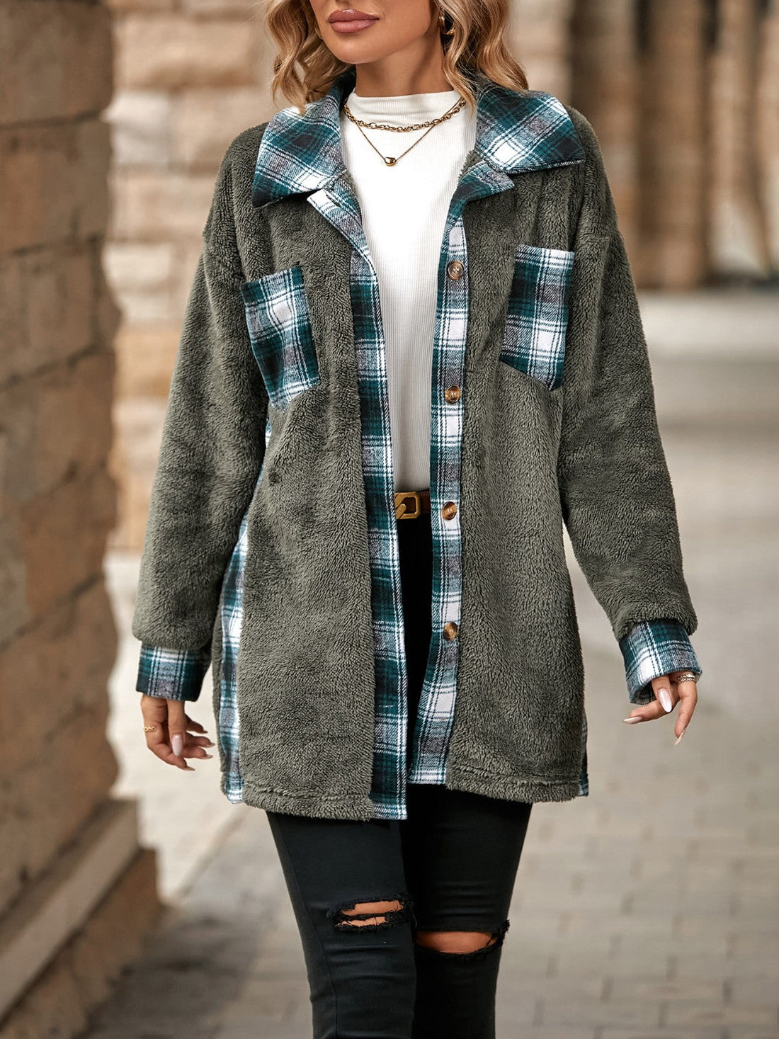 Teddy shacket with plaid accents in dark gray, green, and white, featuring button closure and chest pockets.