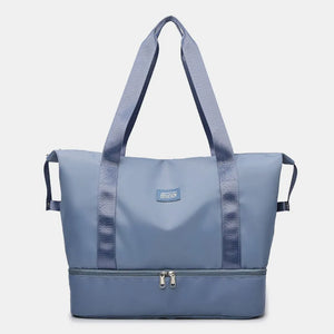 Dusty Blue dual-compartment travel tote with metallic trim and dual zippers.