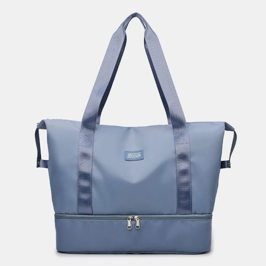 Dusty Blue dual-compartment travel tote with metallic trim and dual zippers.