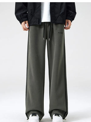 Men's army green sweatpants with black side stripes and drawstring waist.