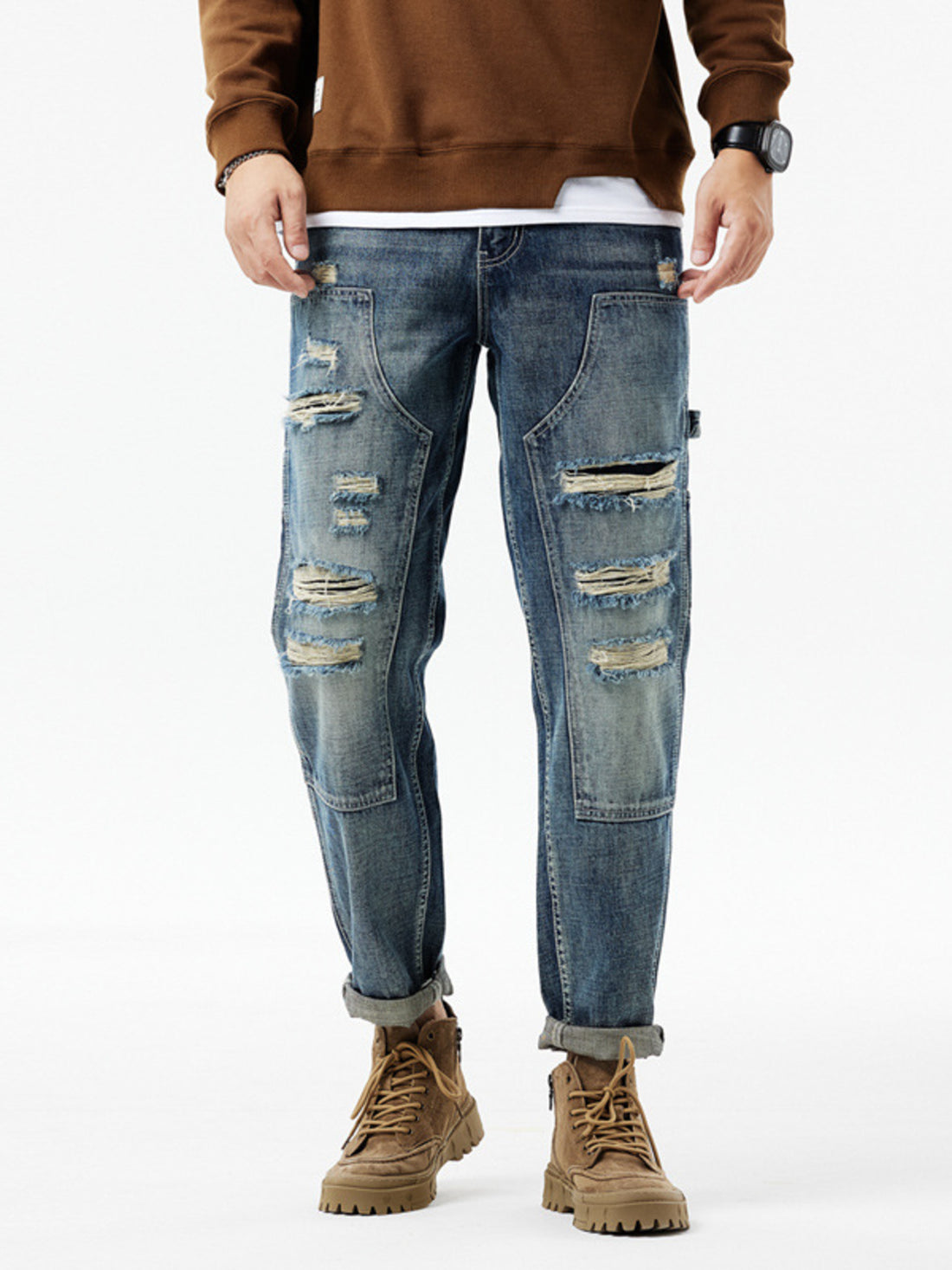 Men's distressed blue denim jeans with utility loop and ripped details