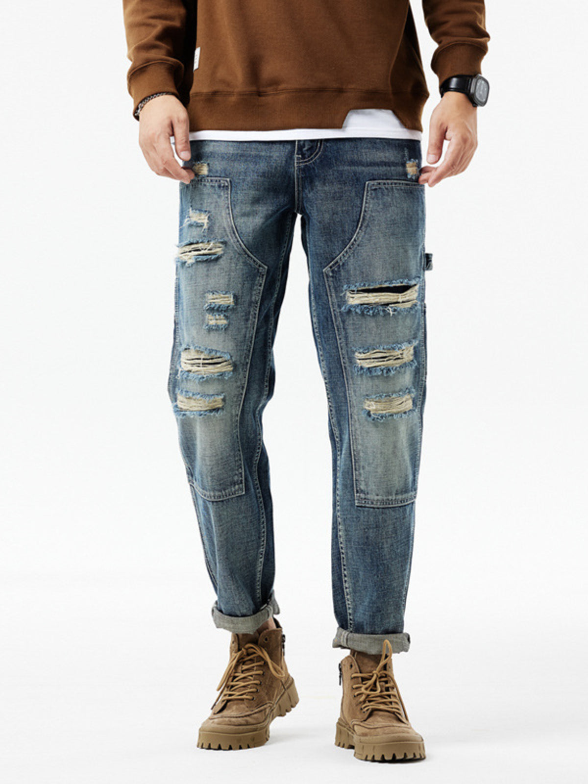Men's distressed blue denim jeans with utility loop and ripped details