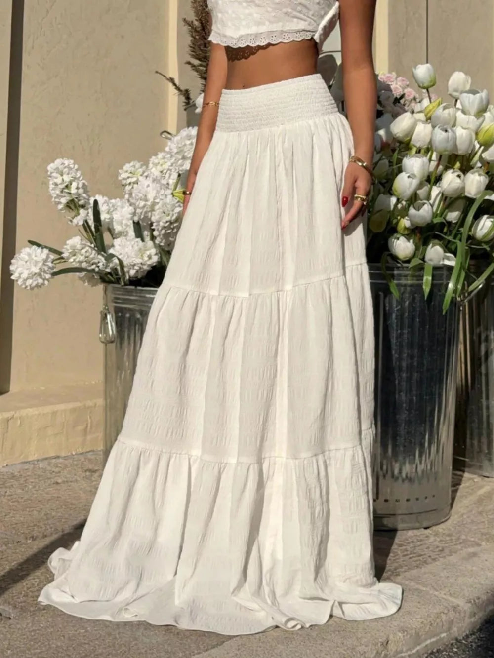 White tiered maxi skirt with smocked waist and crinkled texture