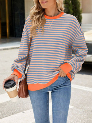 Striped crew neck sweatshirt in blue and coral with orange cuffs and hem.