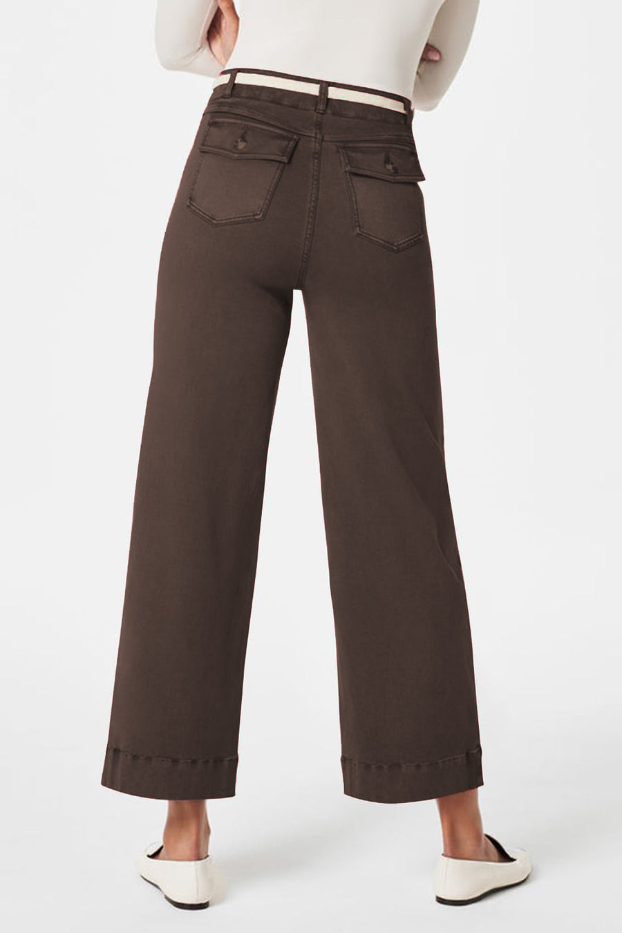 Wide-leg utility denim trousers in dark brown with buttoned flap pockets and a white belt.