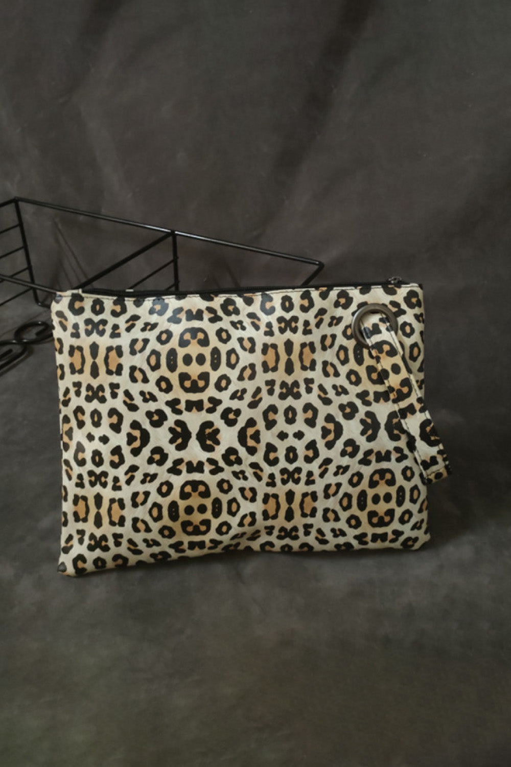 Leopard print zip-top clutch bag with ring detail and wrist strap