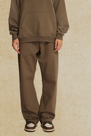 Relaxed fit lounge trousers in olive brown, with a straight leg and elastic waistband.