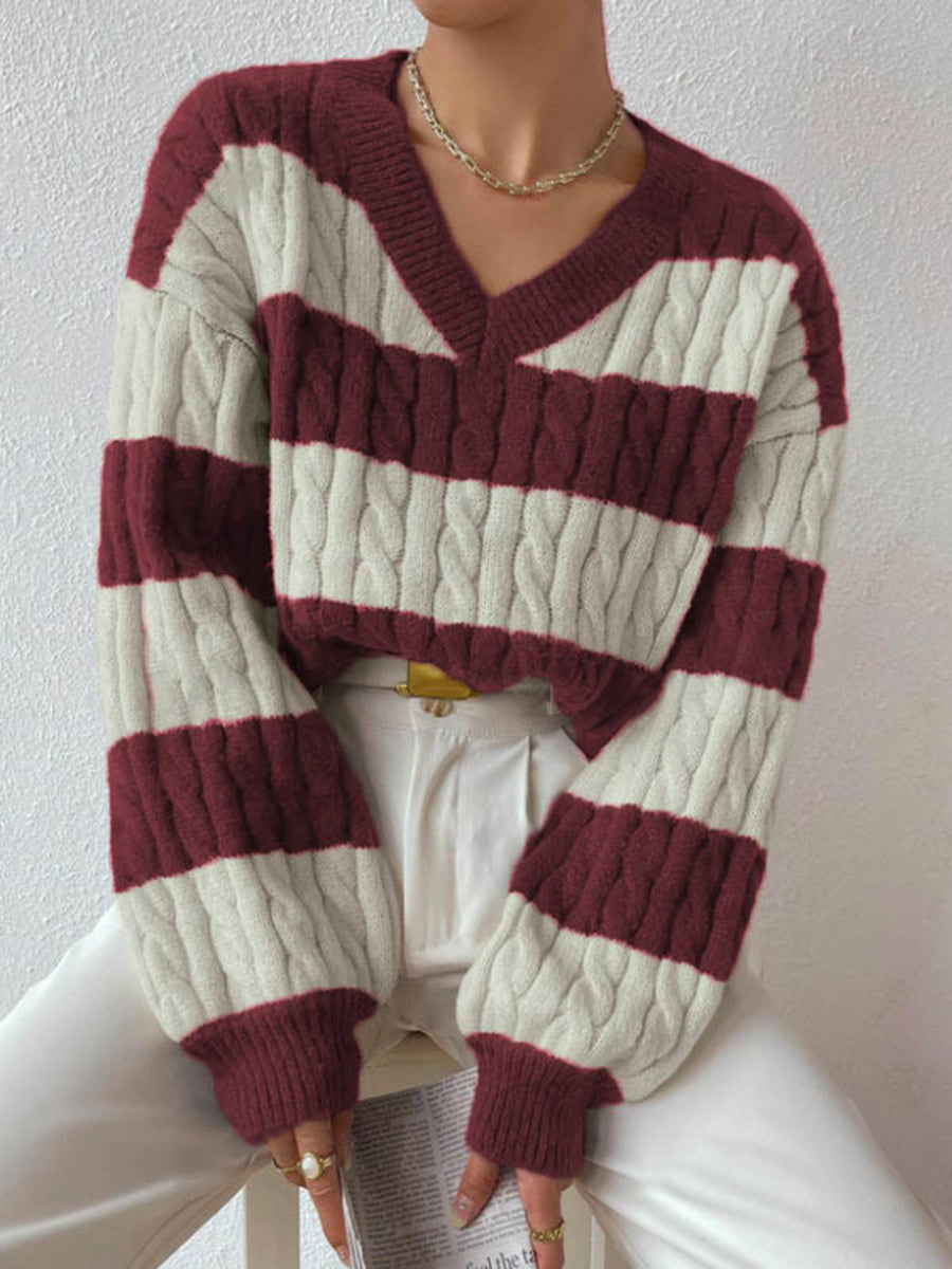 ivory v-neck sweater featuring cable-knit and striped
