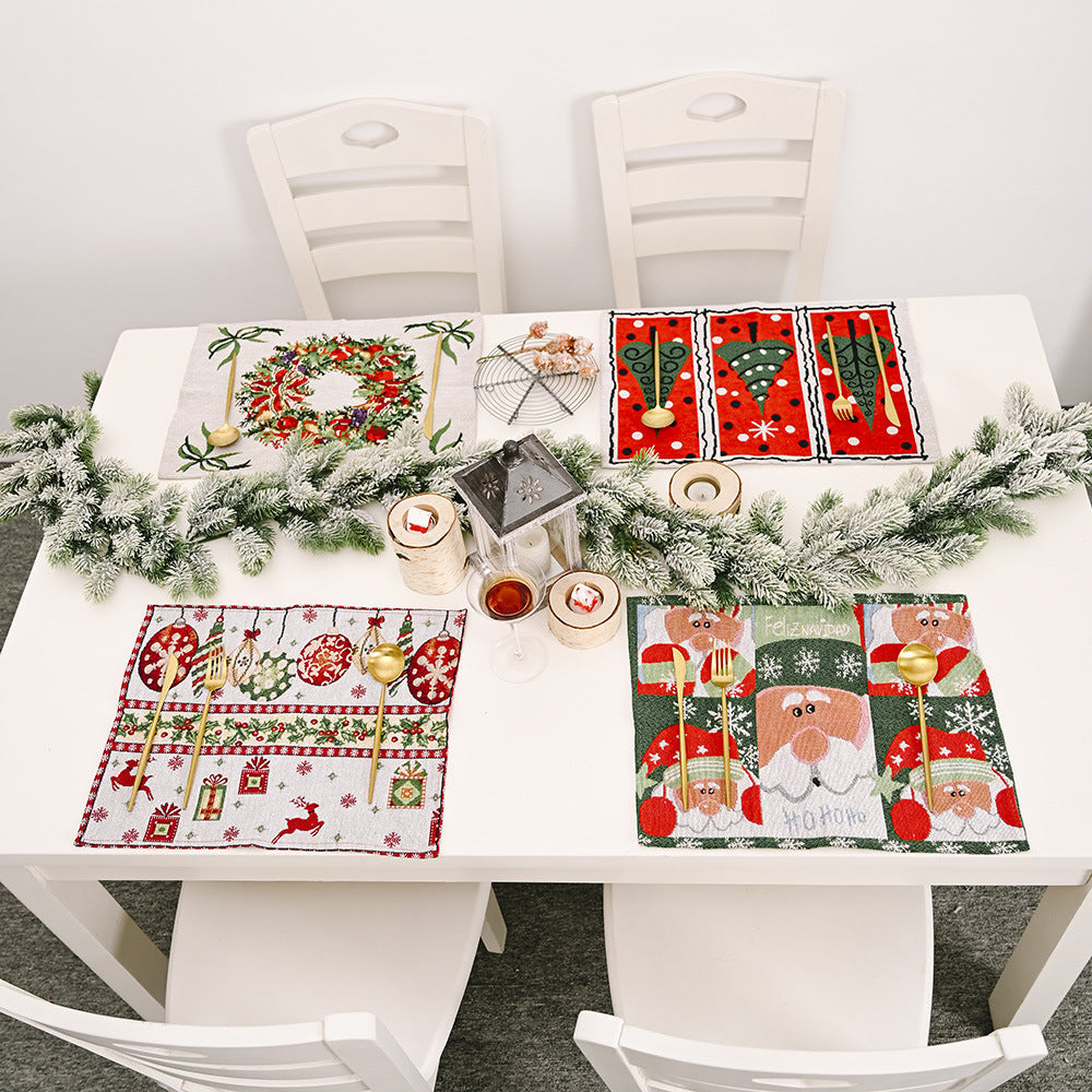 Embroidered Christmas placemats with Santa, wreath, tree, and reindeer designs.