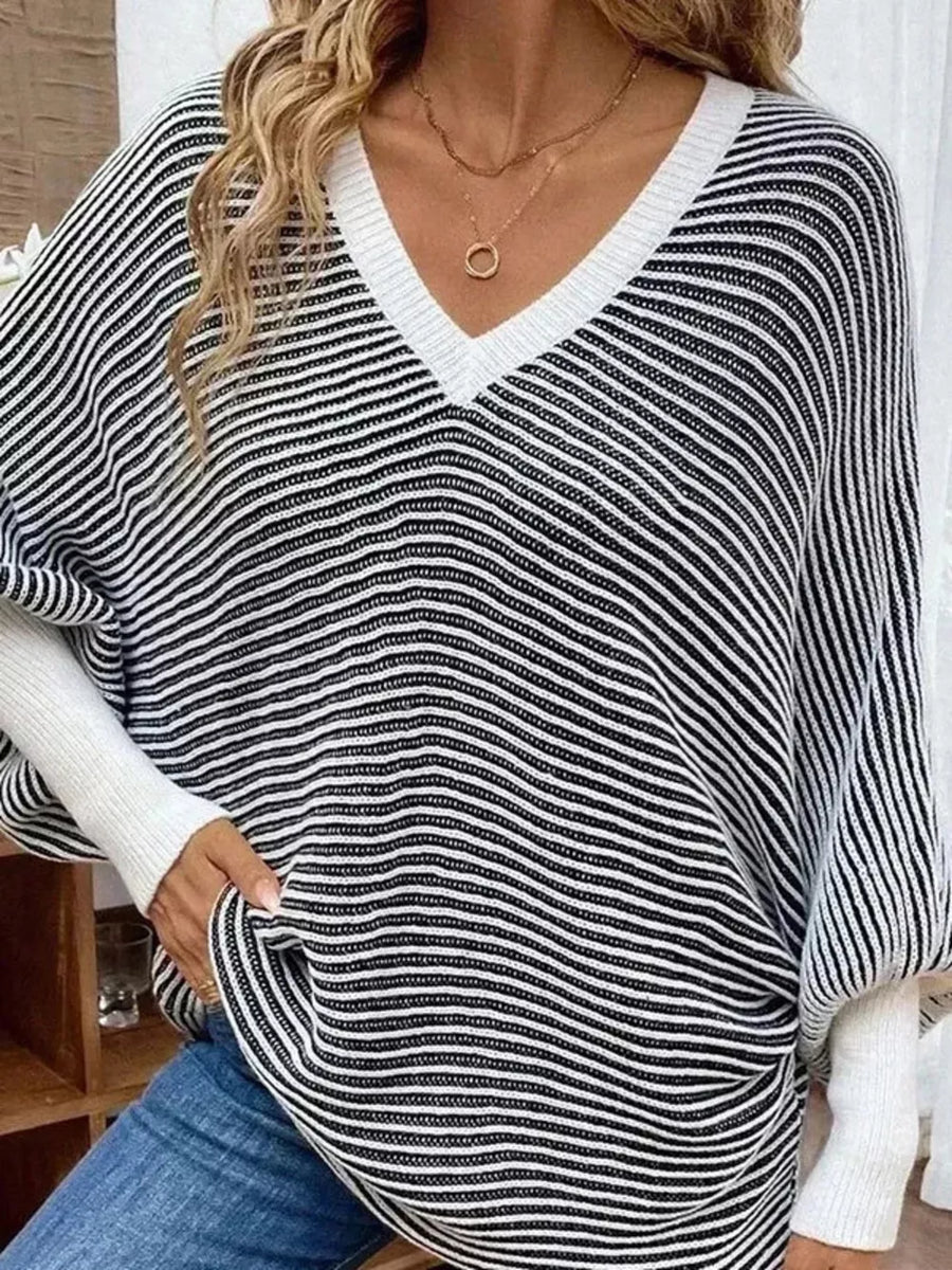 100% polyester Care instructions: Machine wash cold v-neck sweater in Black with loose silhouette