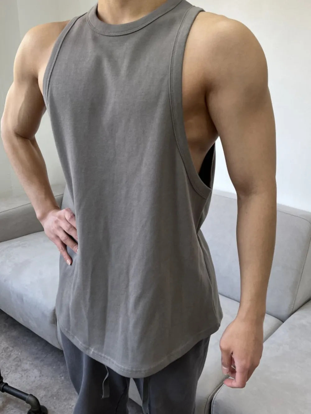 Dark gray sculpted muscle tank top with open sides and a rounded hem.