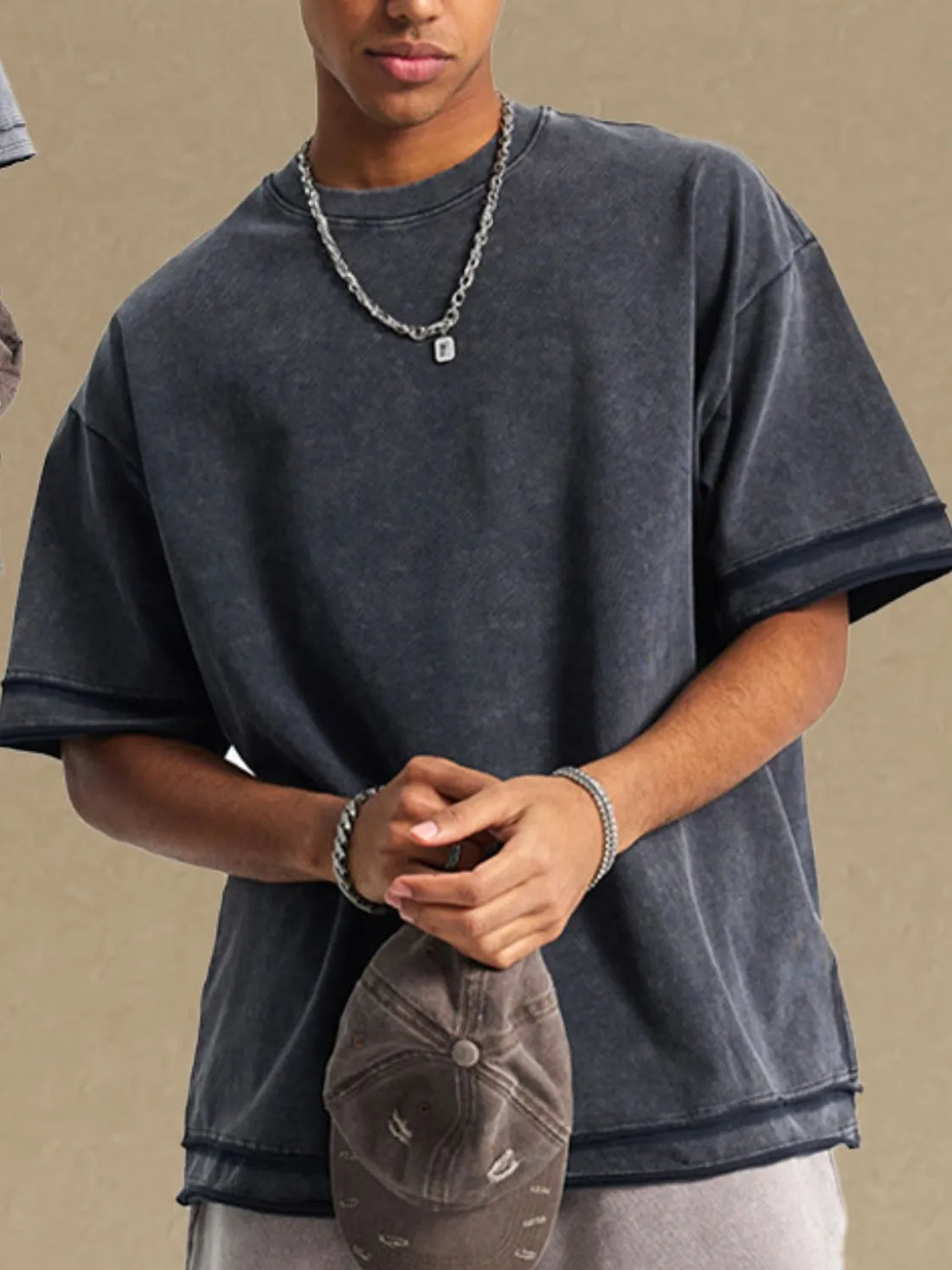 Washed cotton t-shirt in dark gray with raw edges and a relaxed fit.