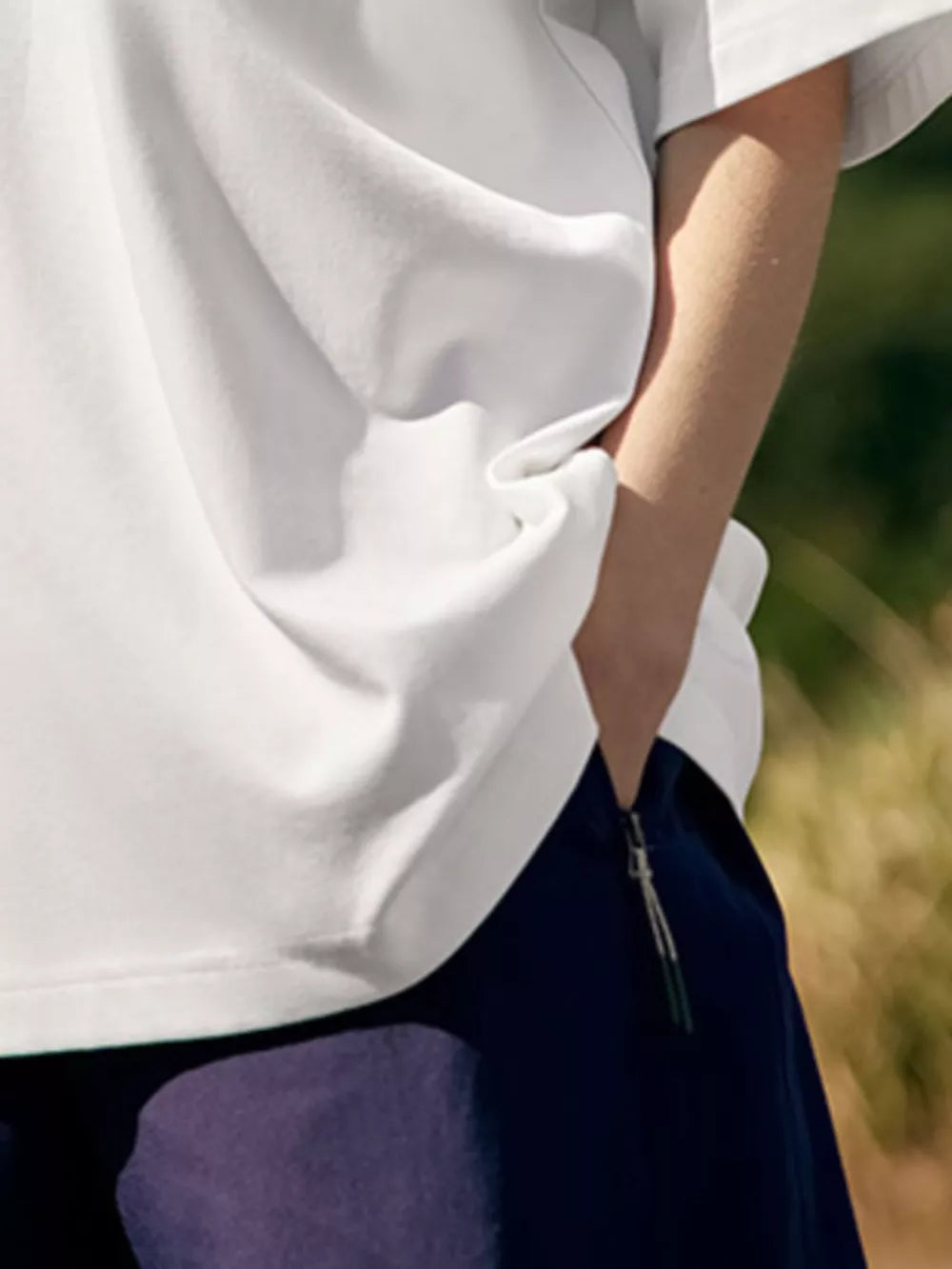 White cotton blend crew neck t-shirt with embroidered tennis detail.