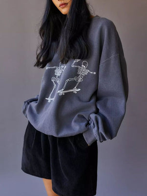 white sweatshirt featuring ribbed cuffs and graphic print