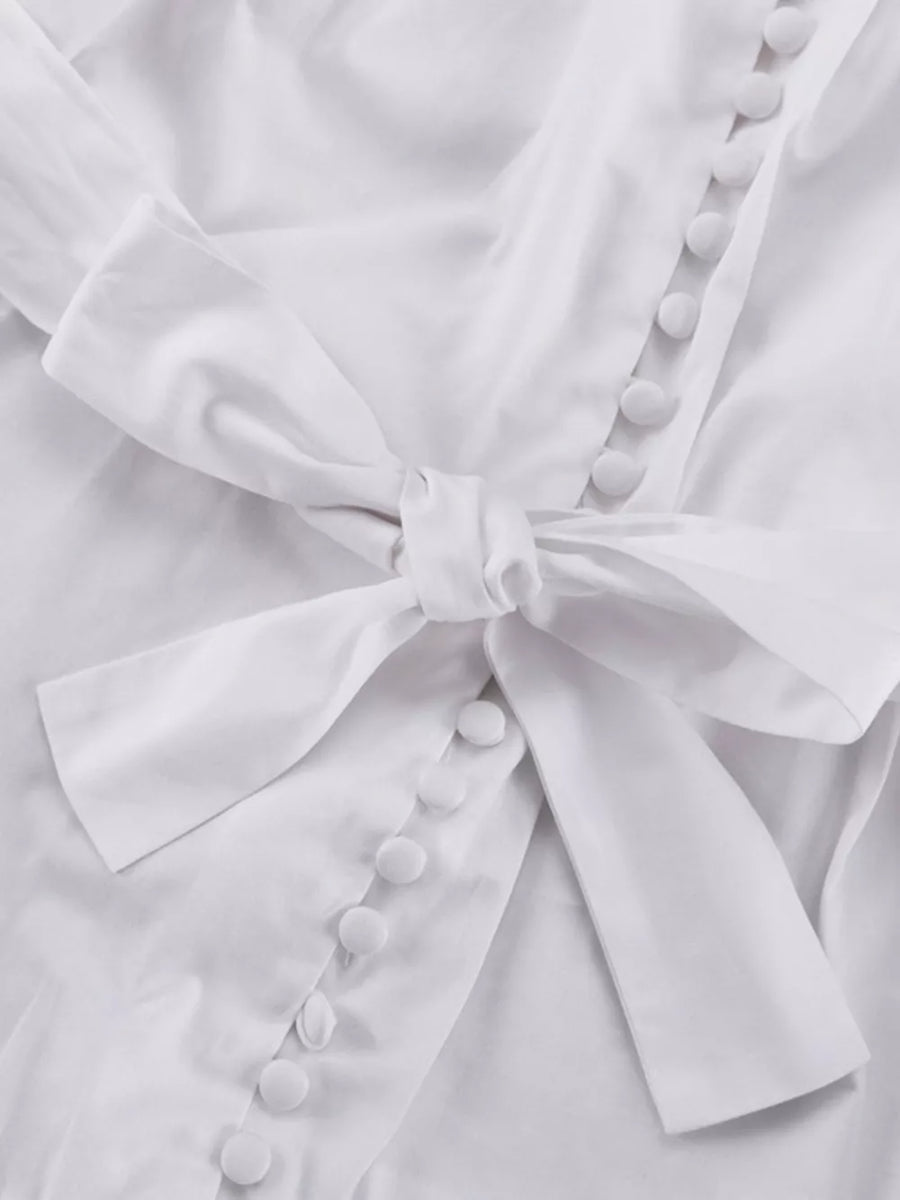 White button-up shirt with a tie waist and fabric-covered buttons