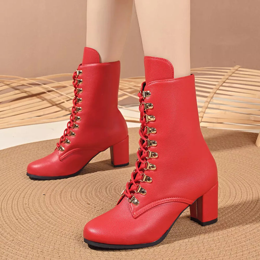Red lace-up block heel boots with gold eyelets and laces.