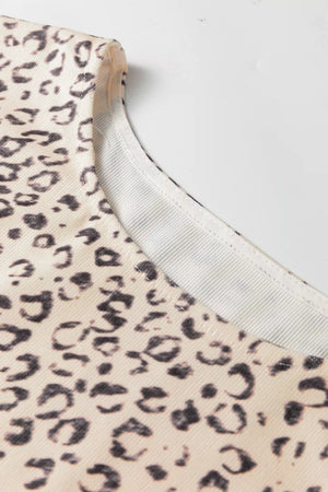Knot detail leopard print tank top in cream and black with a ribbed neckline.