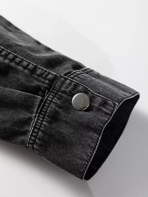Black denim button-up dress with raw hem detail and silver button cuff.