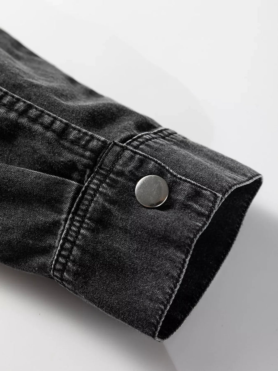 Black denim button-up dress with raw hem detail and silver button cuff.