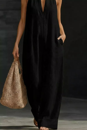 Black halter-neck maternity jumpsuit with pockets, v-neck, and wide legs.