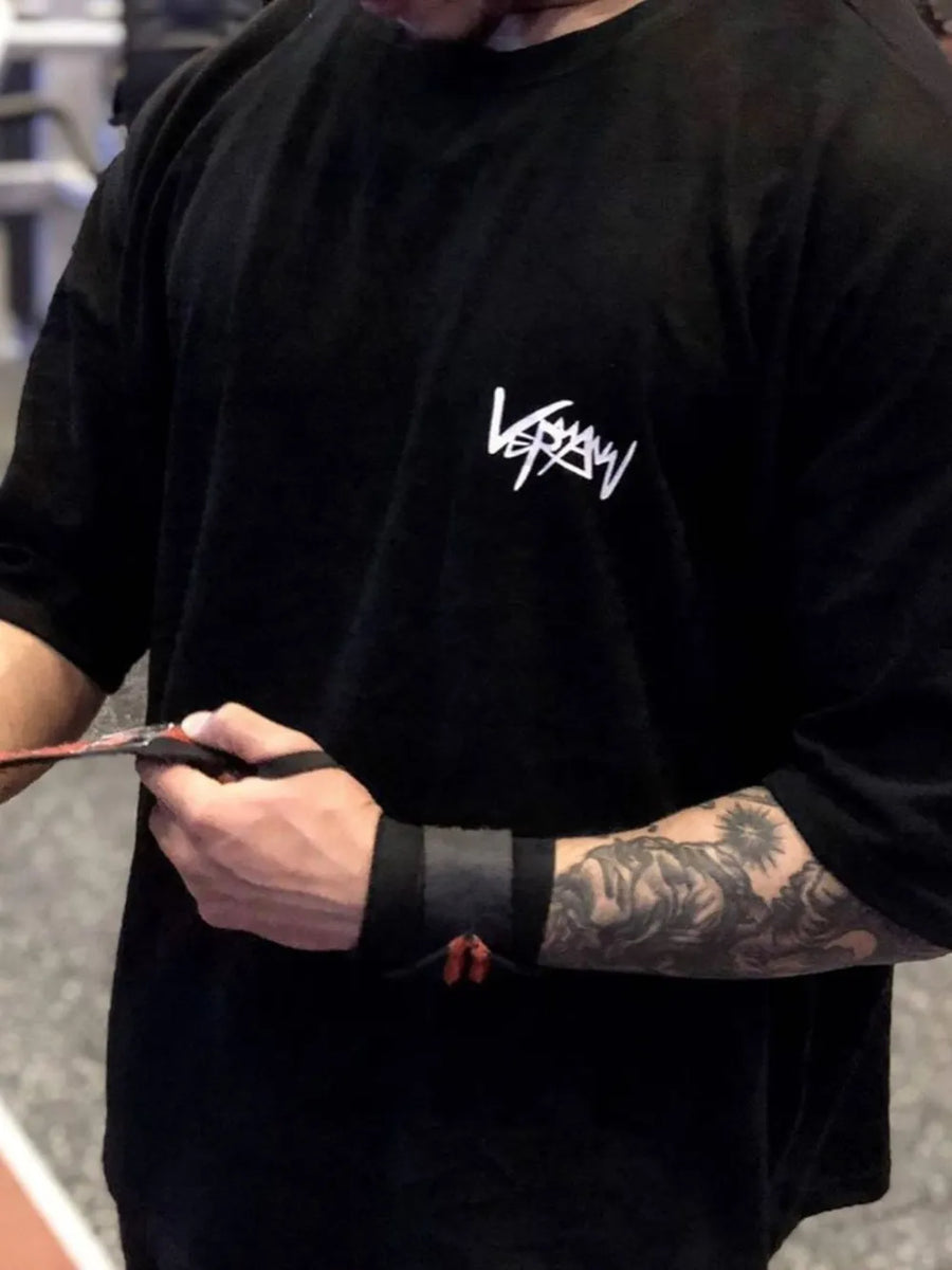 Black oversized graphic tee with white logo, short sleeves, and crew neck.
