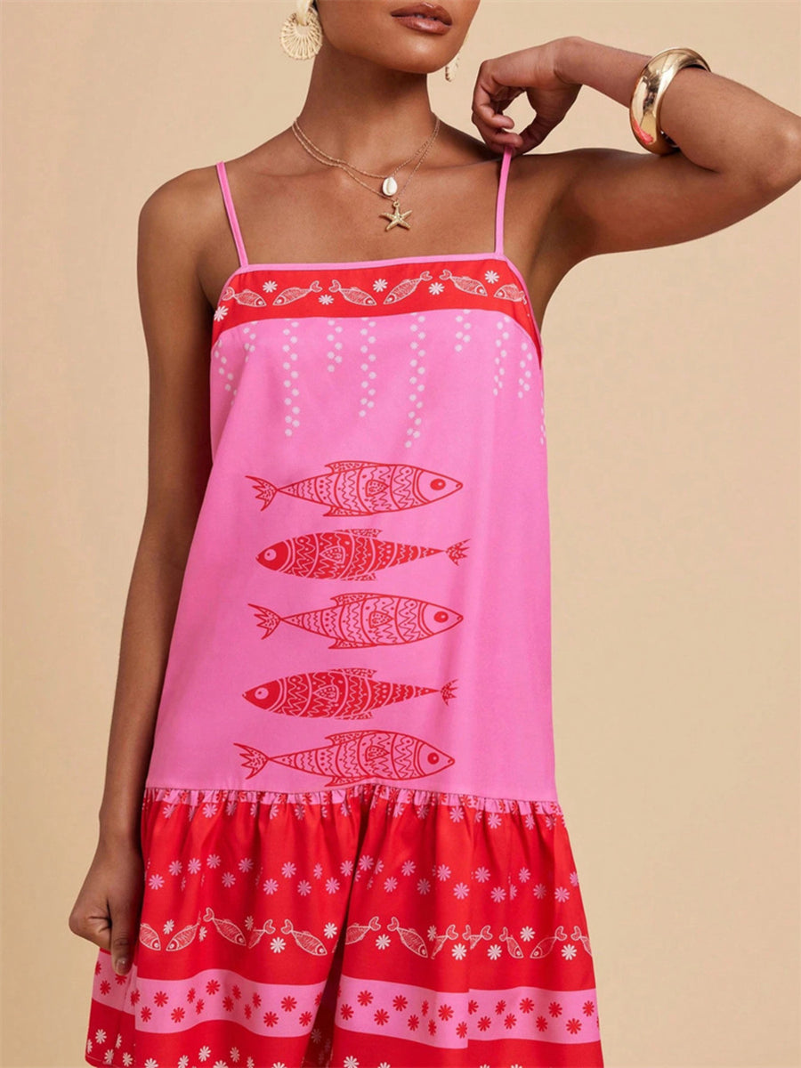 Pink spaghetti strap mini dress with red fish print and tiered ruffle hem.