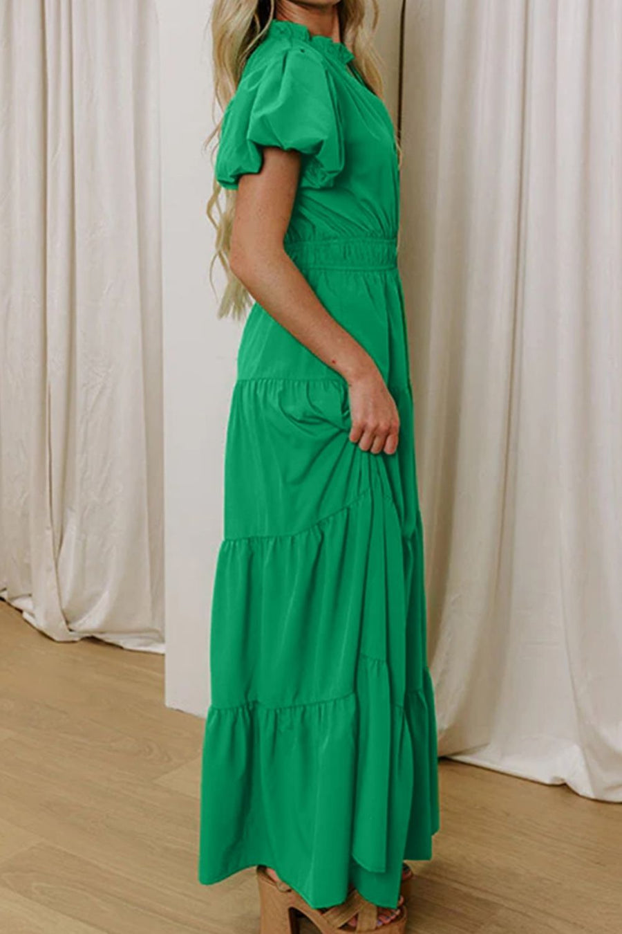 Green maxi dress with puff sleeves, tiered skirt, and cinched waist.