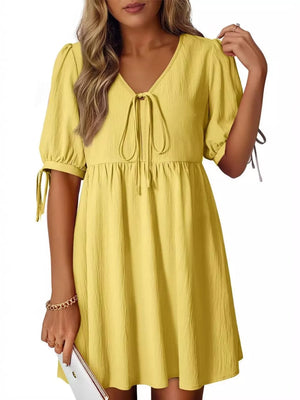 Yellow puff sleeve mini dress with tied neckline and sleeve details