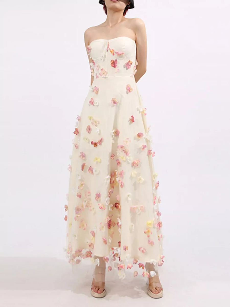Strapless ivory tulle maxi dress with floral appliques and sweetheart neckline.