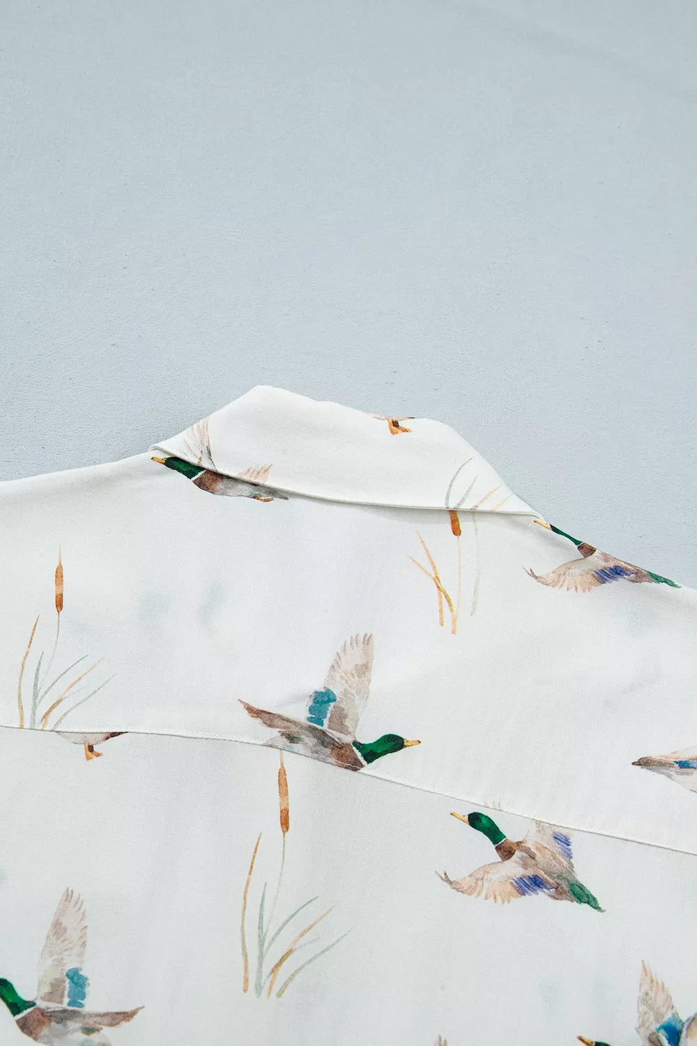 button-up shirt in green with button-front and hip-length