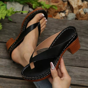 Black toe-post block heel sandals with contrast stitching and wooden heel detail.