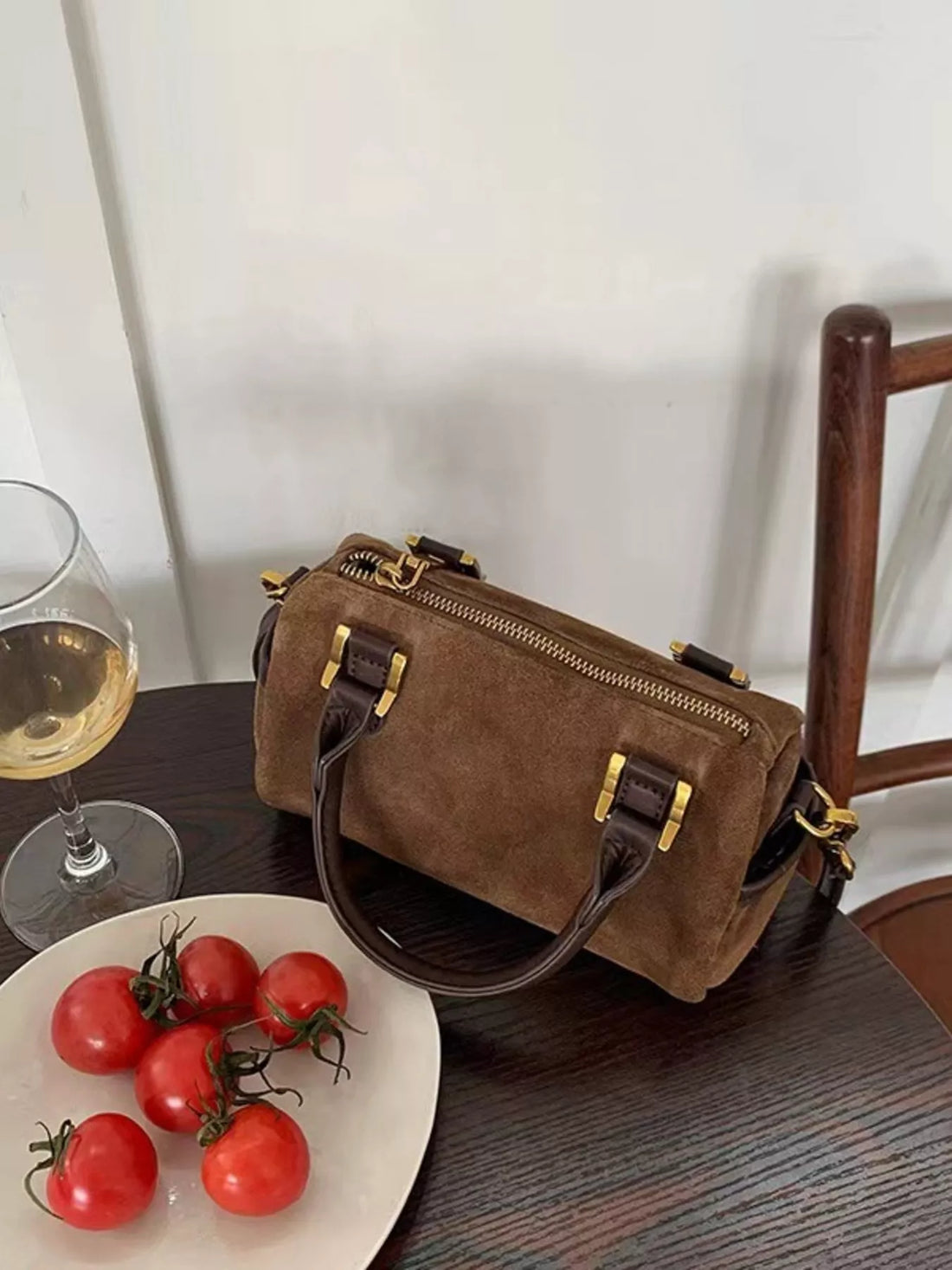 Vintage barrel crossbody bag in coffee brown suede with gold hardware and leather trim.
