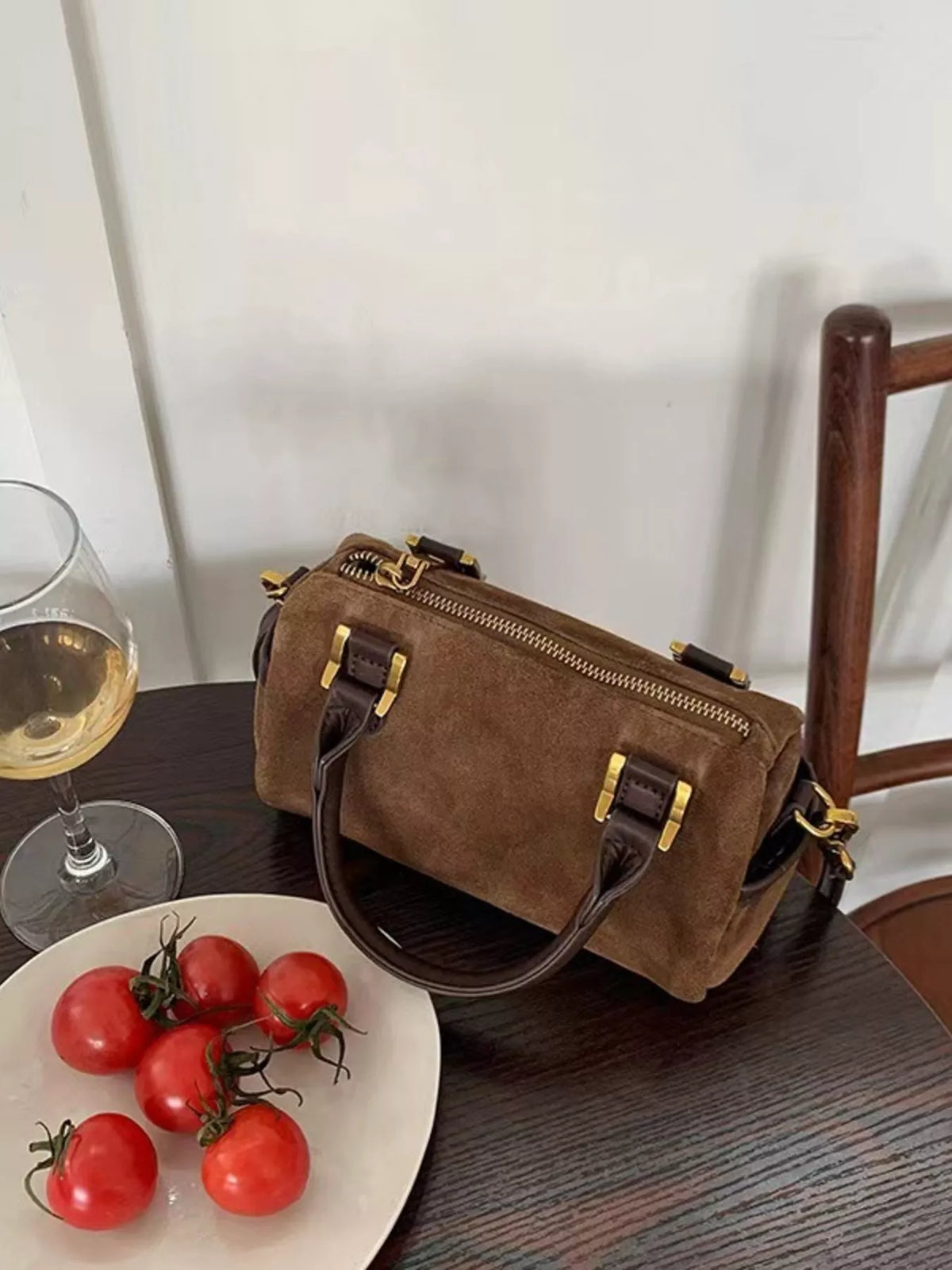 Vintage barrel crossbody bag in coffee brown suede with gold hardware and leather trim.