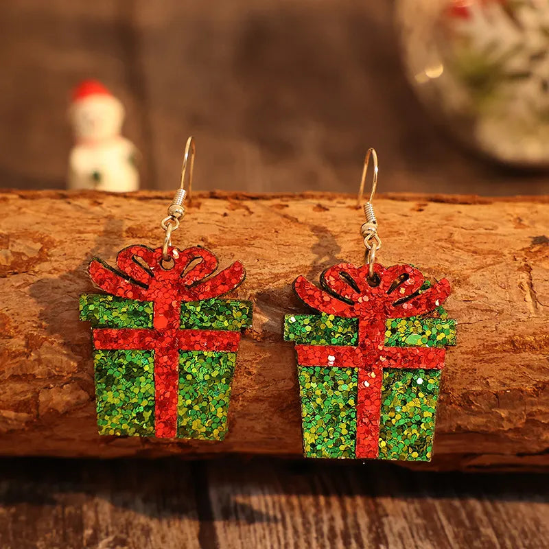Festive glitter gift box drop earrings in green with red ribbon detail.