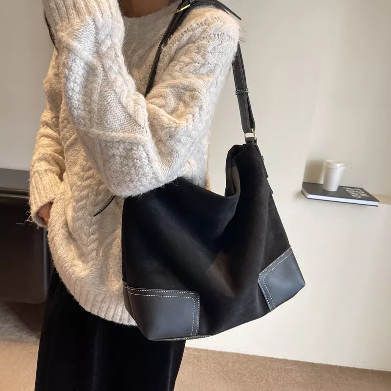 Black suede tote bag with leather accents and contrast stitching