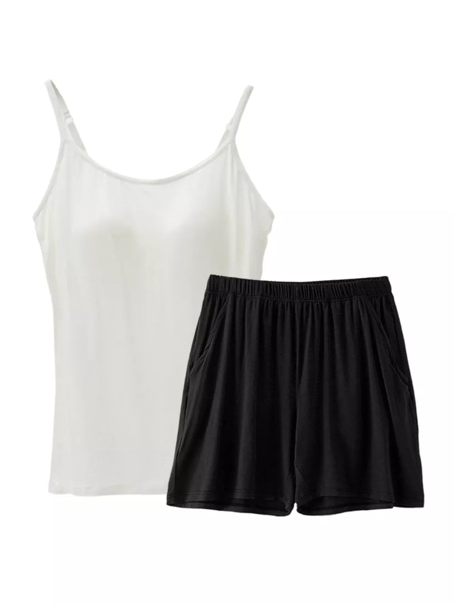 White cami with adjustable straps and black shorts with pockets pajama set