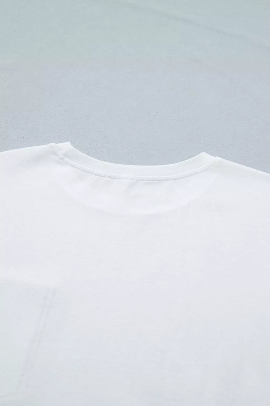 White cotton t-shirt with crew neck and pocket detail