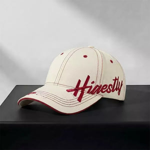 Ivory cotton baseball cap with red embroidery and contrast stitching.
