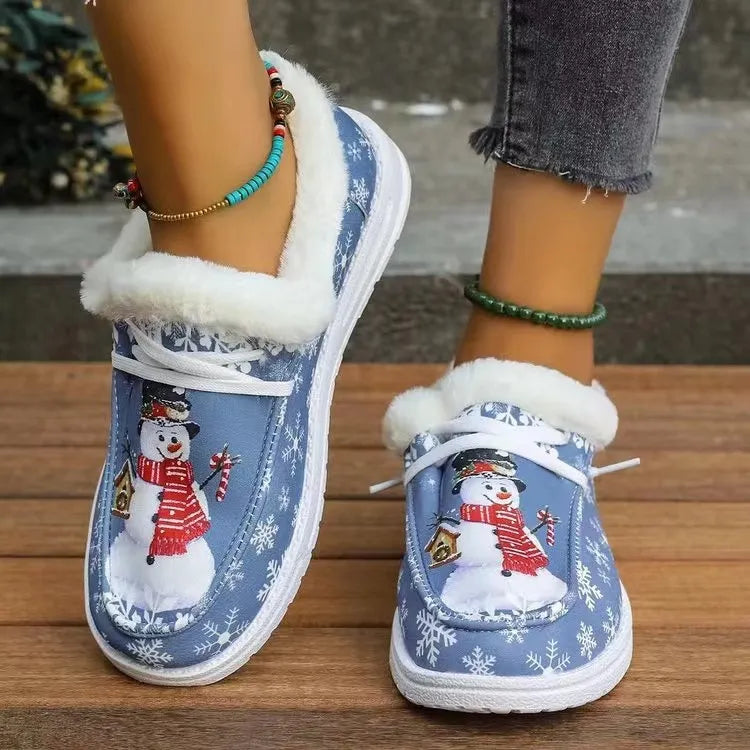 Light blue faux-fur lined loafers with snowman print and snowflakes.