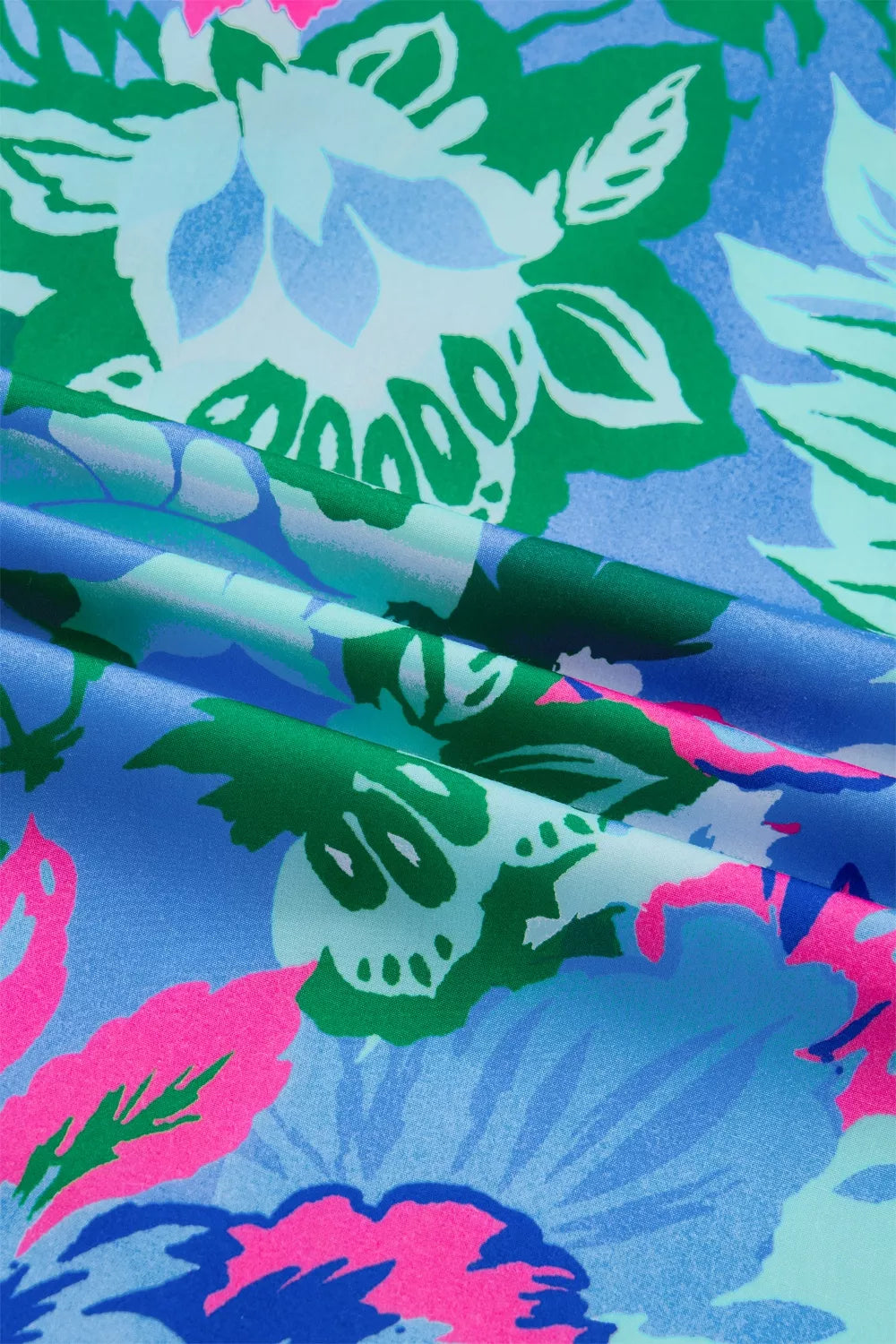 Vibrant floral print blouse with a V-neck and relaxed fit.