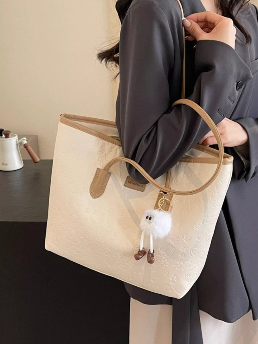 Embossed PU leather tote bag in Khakis with a fuzzy charm and tan trim.