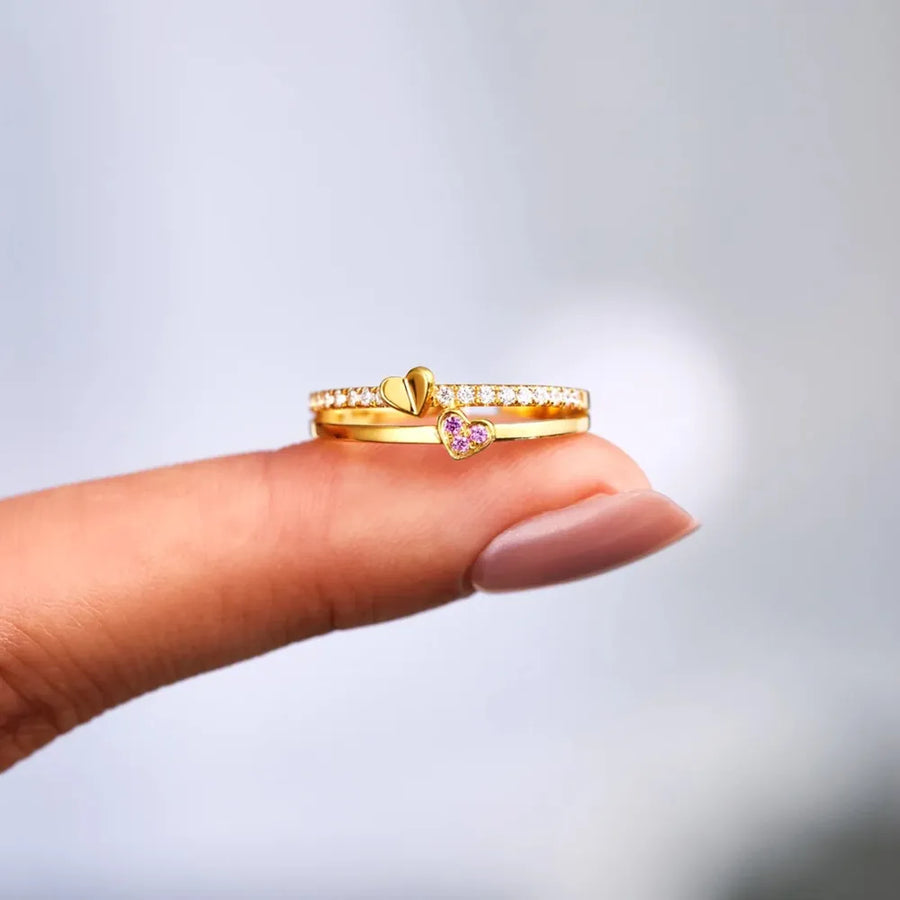 Gold layered rings with heart details and cubic zirconia accents.