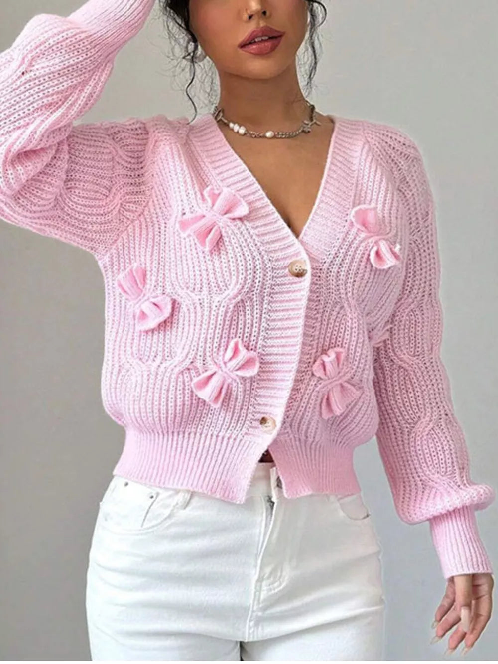 Pink cardigan featuring cable knit and cable knit