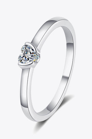 Silver ring with a clear heart-cut solitaire diamond.