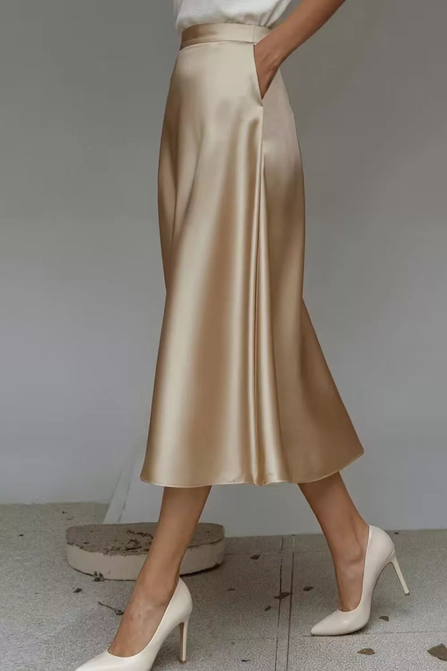 Lustrous midi skirt in Khaki with hidden pockets and A-line cut.