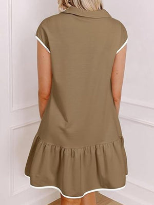 Taupe cap sleeve ruffle dress with white trim detail.