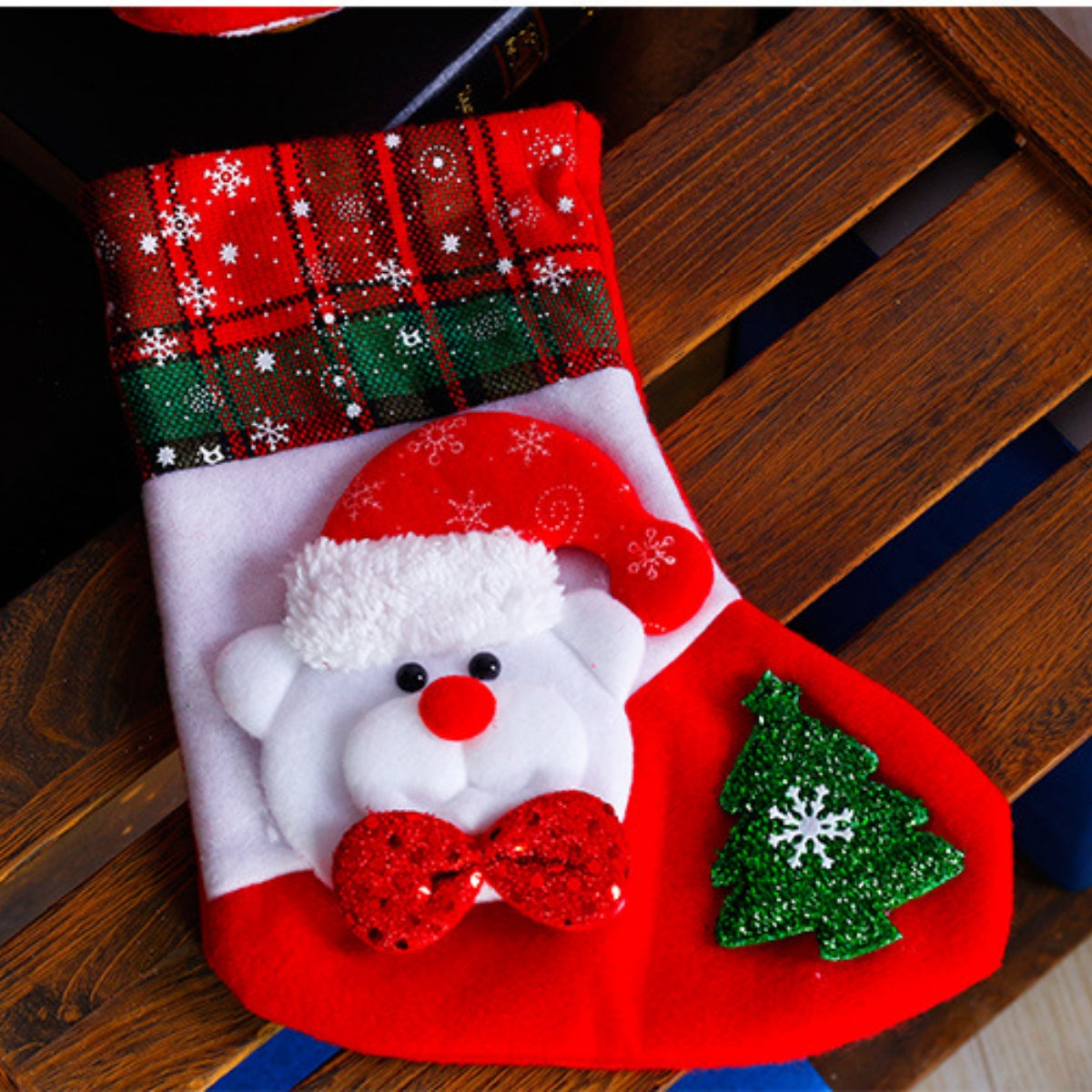 Festive Santa stocking with red plaid cuff, white body, and glittery red bow.